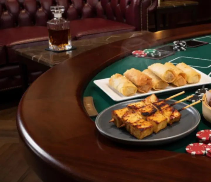 Assorted small plates placed beside ceramic poker chips on a wooden table